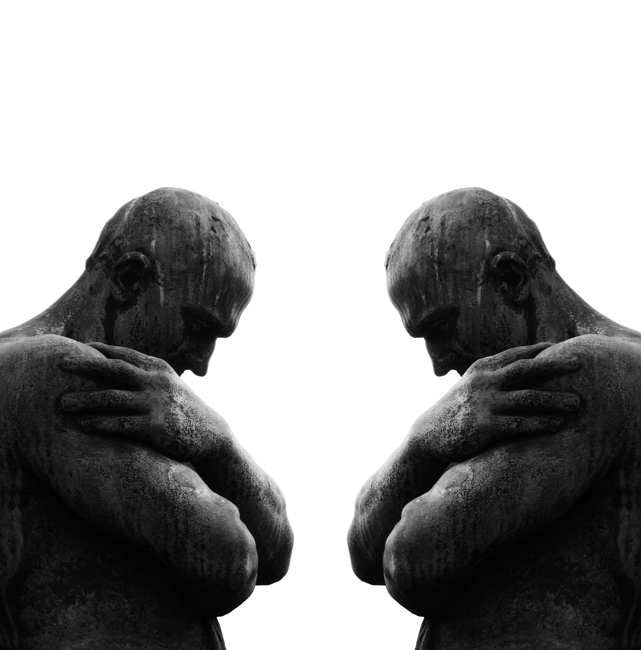 'A black and white mirrored image of a stone man holding his ches, symbolyzing duality and the ego as the illusion.'